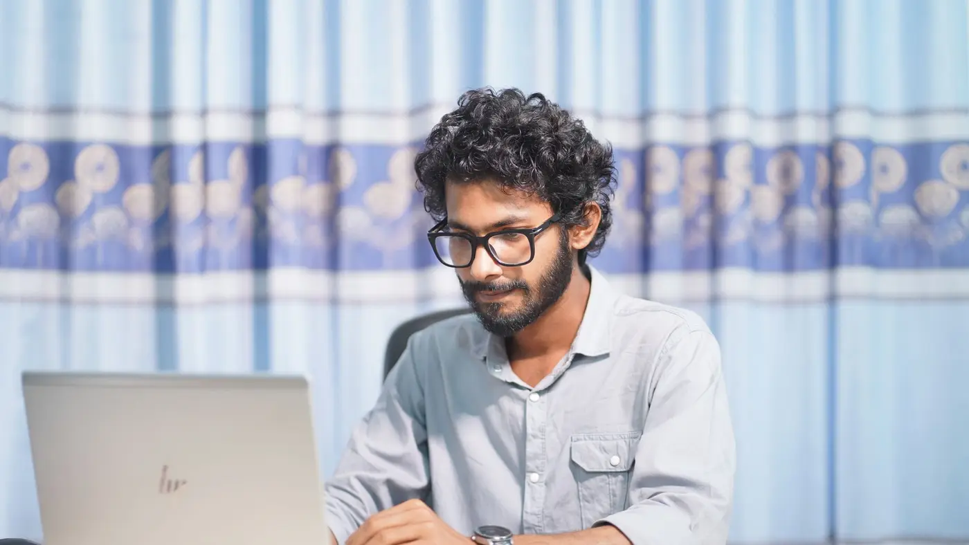 A team member working remotely at a laptop